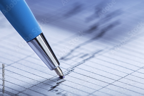 Accounting document with pen, money, coins and checking financial chart. Concept of banking, financial report and financial audit.