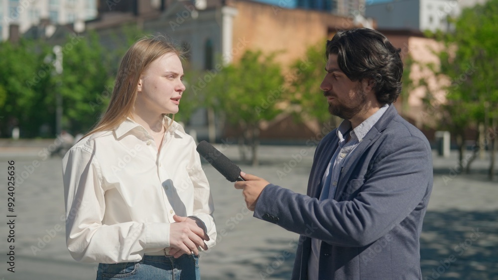 Outdoor interview in the park: Reporter Discusses with Local Expert Outdoor interview in the park: Reporter Discusses with Local Expert