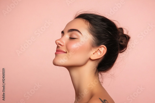 A close up of a woman's face with tattoos and her eyes closed