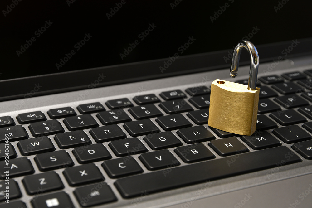 Computer security concept with open padlock on the keyboard Computer security concept with open padlock on the keyboard