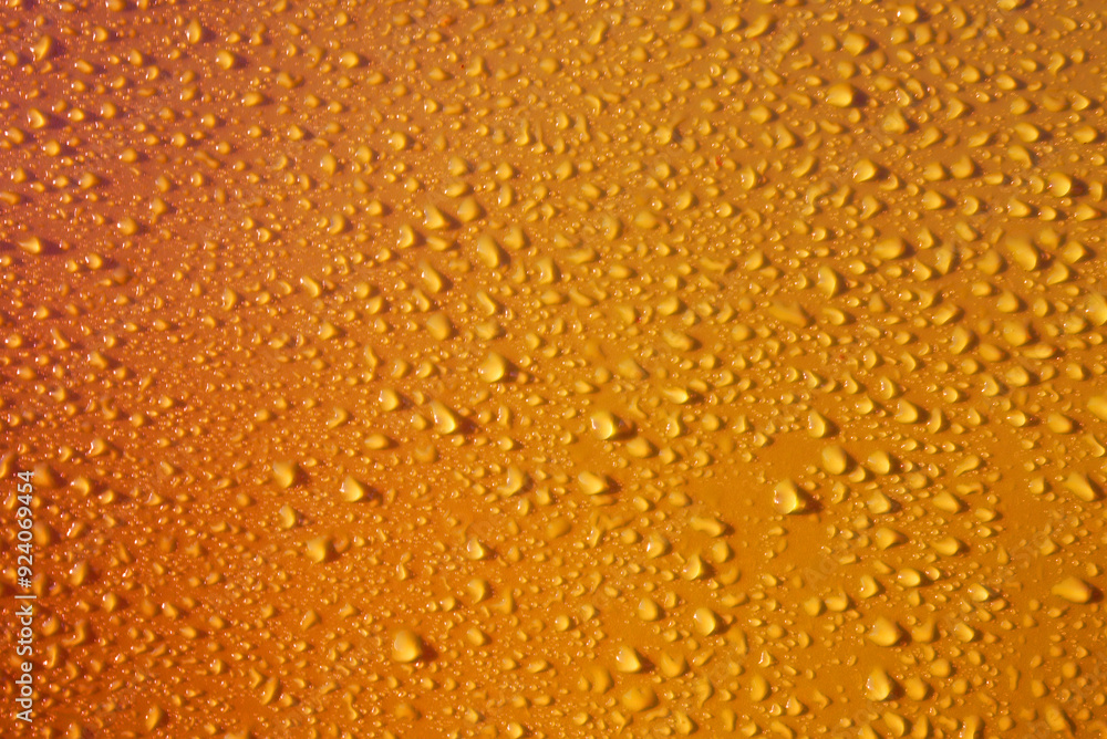 Drops on orange yellow background. Water drops on dark orange background. Shades of yellow orange colour Abstarct wet texture with bubbles. Raindrop, pure water droplets condensed for banner design Drops on orange yellow background. Water drops on dark orange background. Shades of yellow orange colour Abstarct wet texture with bubbles. Raindrop, pure water droplets condensed for banner design