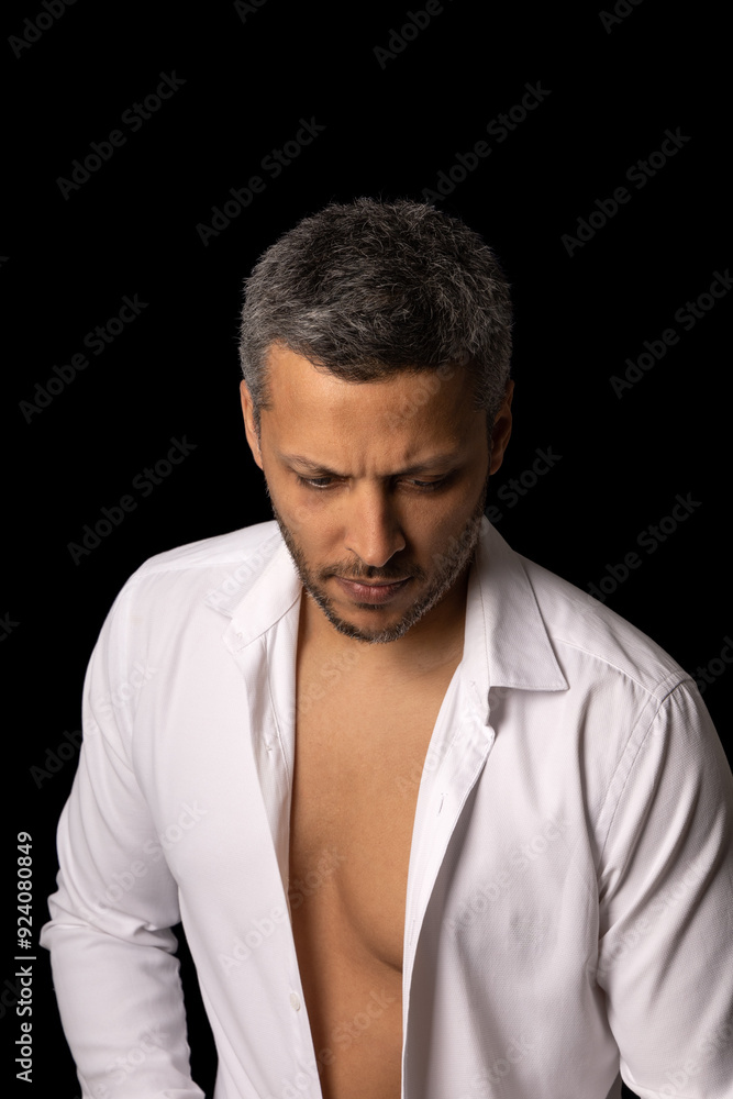 Obraz premium A man with a shaved head and a beard is wearing a white shirt