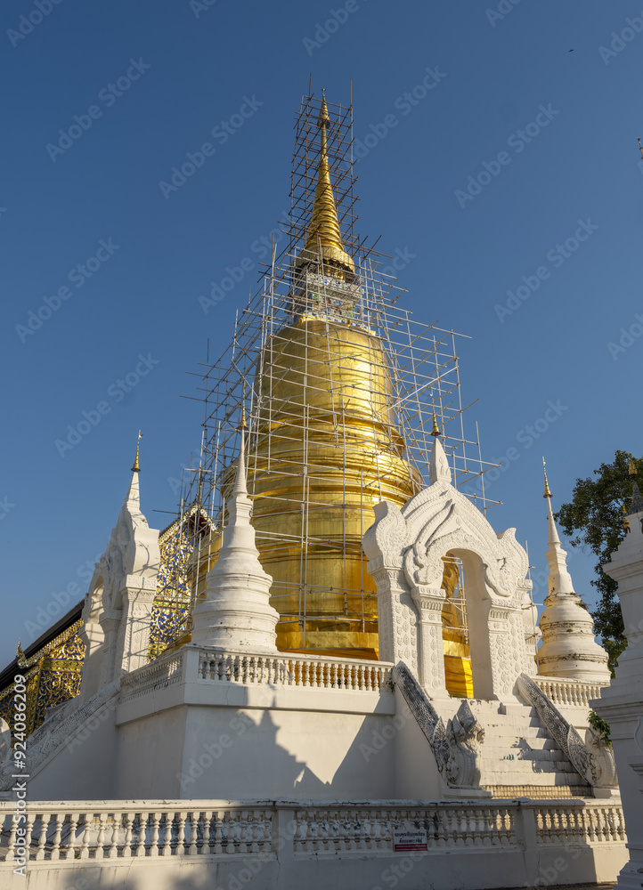 Whitewashed chedi of Wat Suan Dok covered with bamboo scaffolding in Chiang Mai, Thailand Whitewashed chedi of Wat Suan Dok covered with bamboo scaffolding in Chiang Mai, Thailand