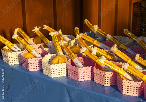 Offering of encens in front of Chedi Phrathatluang in the Wat Phra Singh Temple in Chiang Mai, Thailand

 photo