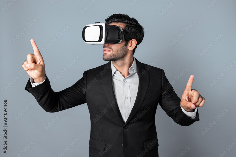Skilled business man looking at data analysis while wearing VR glasses and suit. Project manager checking and choosing while using visual reality goggles or headset. Innovation technology. Deviation.