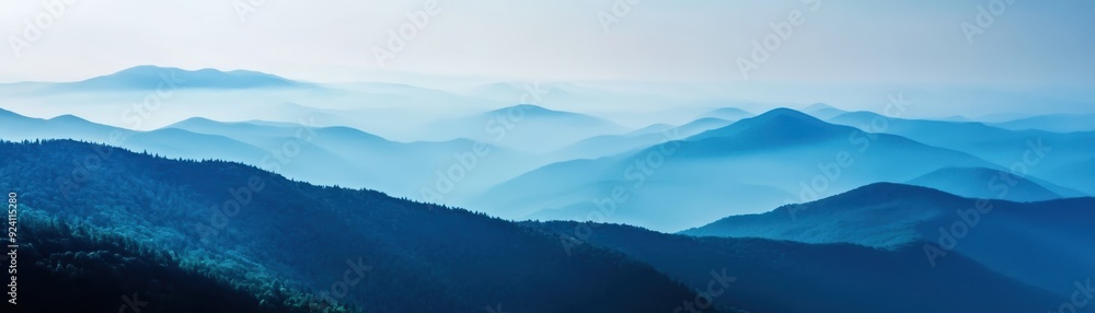 A mesmerizing view of blue mountains stretching into the horizon, enveloped in mist and creating a serene and tranquil atmosphere. A mesmerizing view of blue mountains stretching into the horizon, enveloped in mist and creating a serene and tranquil atmosphere.