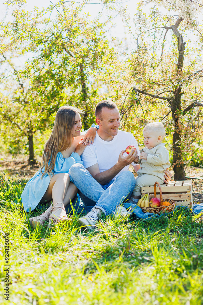 Father and mother holding little son in nature, concept of beautiful family bonds. Family portrait of parents with a little son. The concept of a happy family Father and mother holding little son in nature, concept of beautiful family bonds. Family portrait of parents with a little son. The concept of a happy family