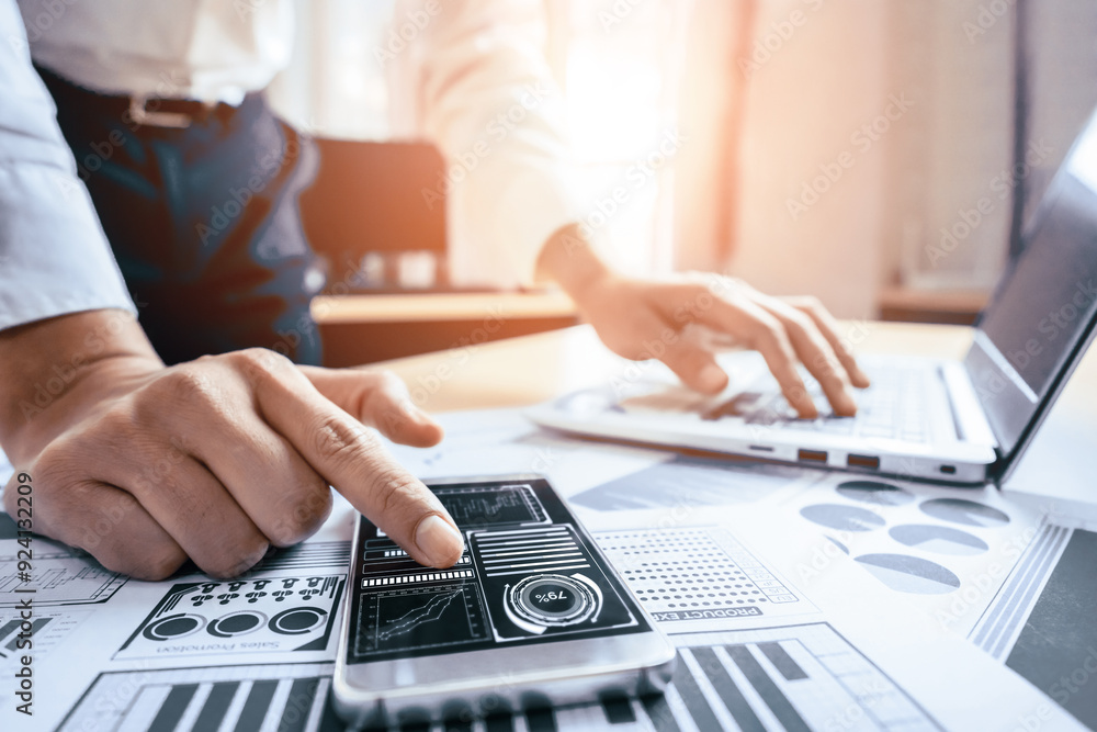 Businessman accountant or financial expert analyze business report graph and finance chart at corporate office. Concept of finance economy, banking business and stock market research. uds Businessman accountant or financial expert analyze business report graph and finance chart at corporate office. Concept of finance economy, banking business and stock market research. uds
