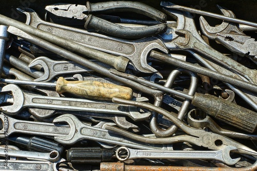 set of different iron gray dirty industrial old wrenches for transport with pliers and screwdrivers lie in tool box