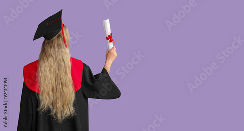 Female graduating student in mortar board with diploma on lilac background, b...