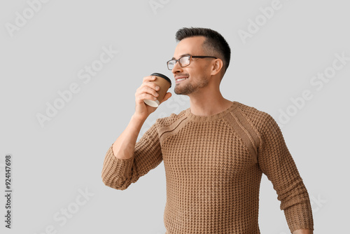 Happy young man drinking co...