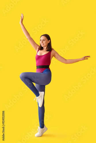 Sporty young woman on yello...
