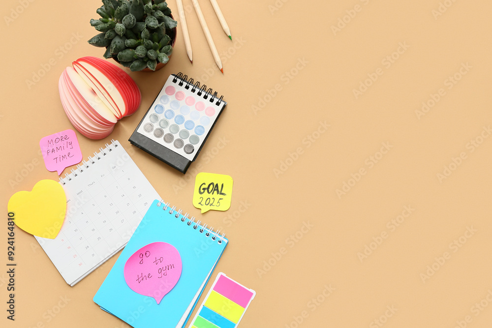 Sticky notes with to do plans, notebook and calendars on beige background. New year goals concept Sticky notes with to do plans, notebook and calendars on beige background. New year goals concept