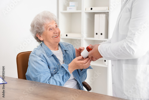 Senior woman taking pill bo...