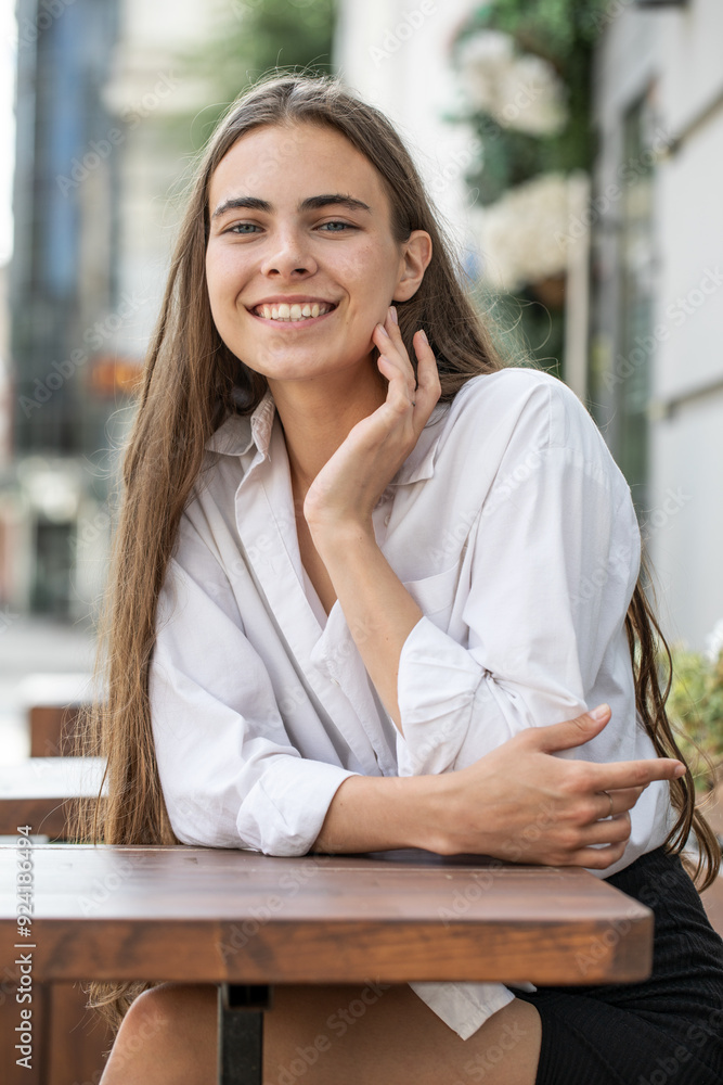 Fototapeta premium Portrait of a young beautiful woman in white shirt