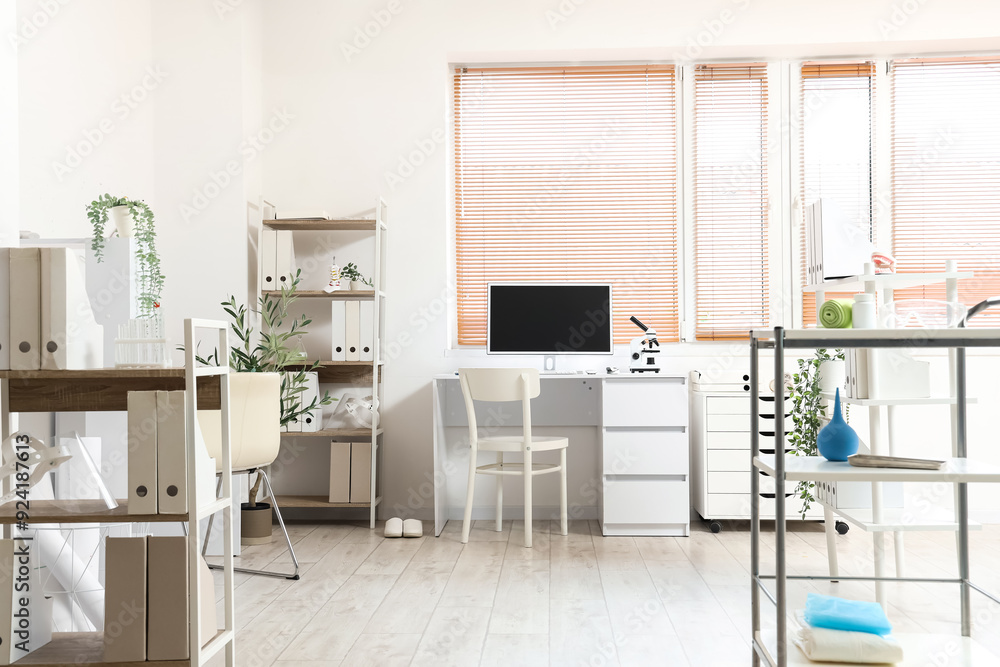 Fototapeta premium Interior of medical office with doctor's workplace and shelf units