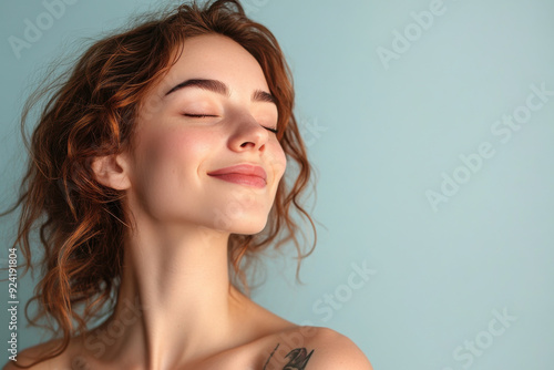 A close up of a woman's face with tattoos and her eyes closed