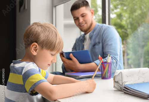 Young man doing homework wi...