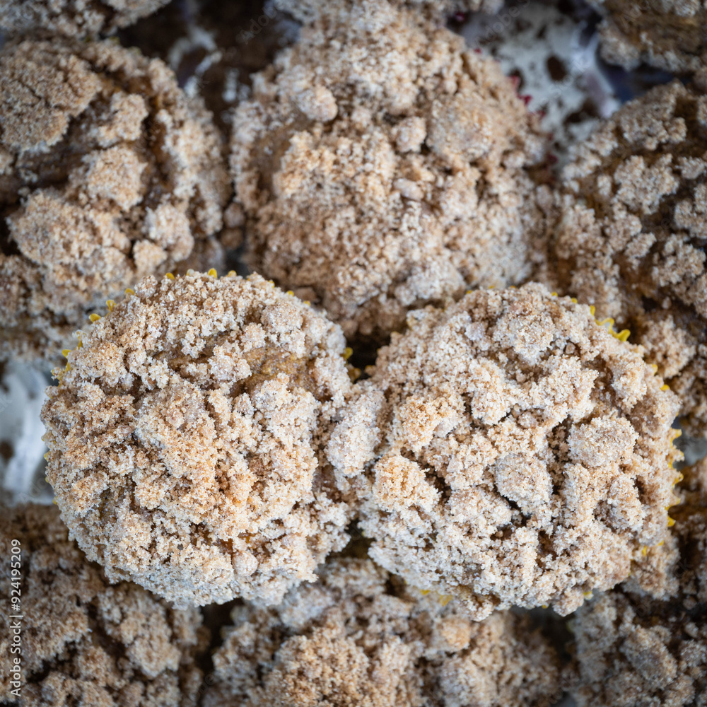 Pumpkin cream cheese muffins with strudel topping close-up, top-down view. Pumpkin cream cheese muffins with strudel topping close-up, top-down view.