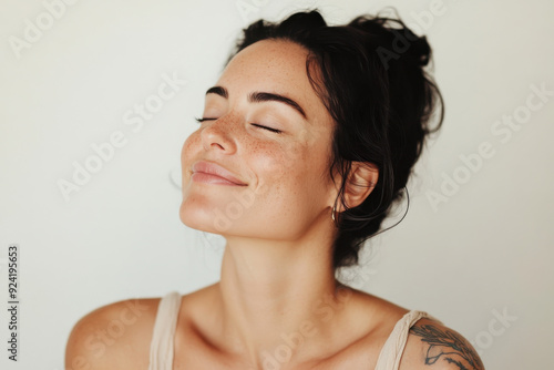 Wallpaper Mural A close up of a woman's face with tattoos and her eyes closed Torontodigital.ca