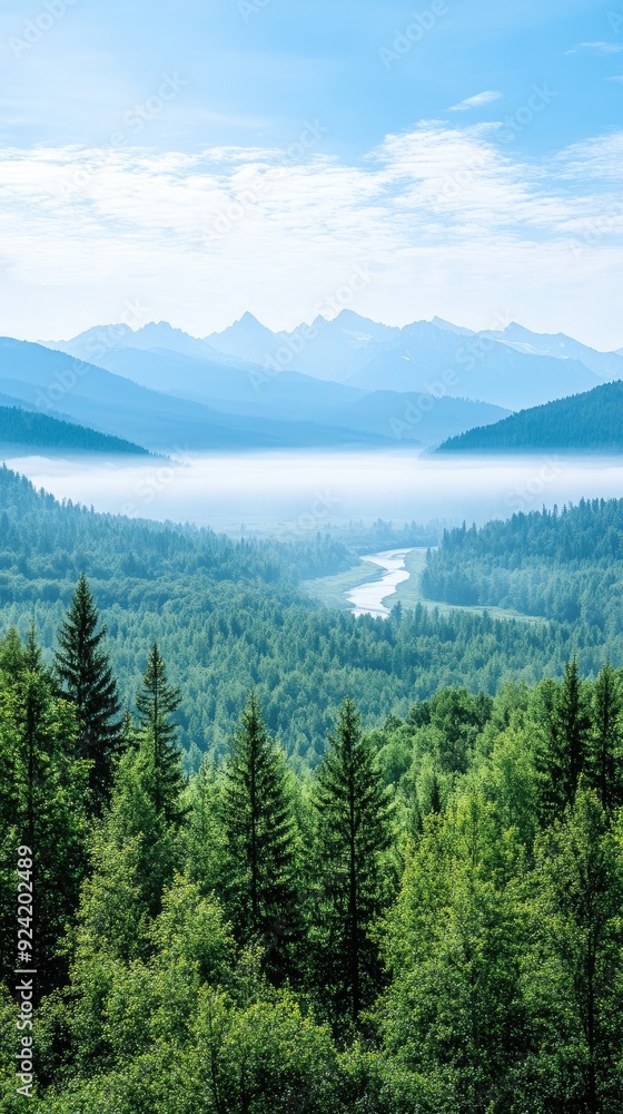Obraz premium The sun rises over National Park, casting golden light on the mountains and lush forests while a river winds through the verdant landscape below