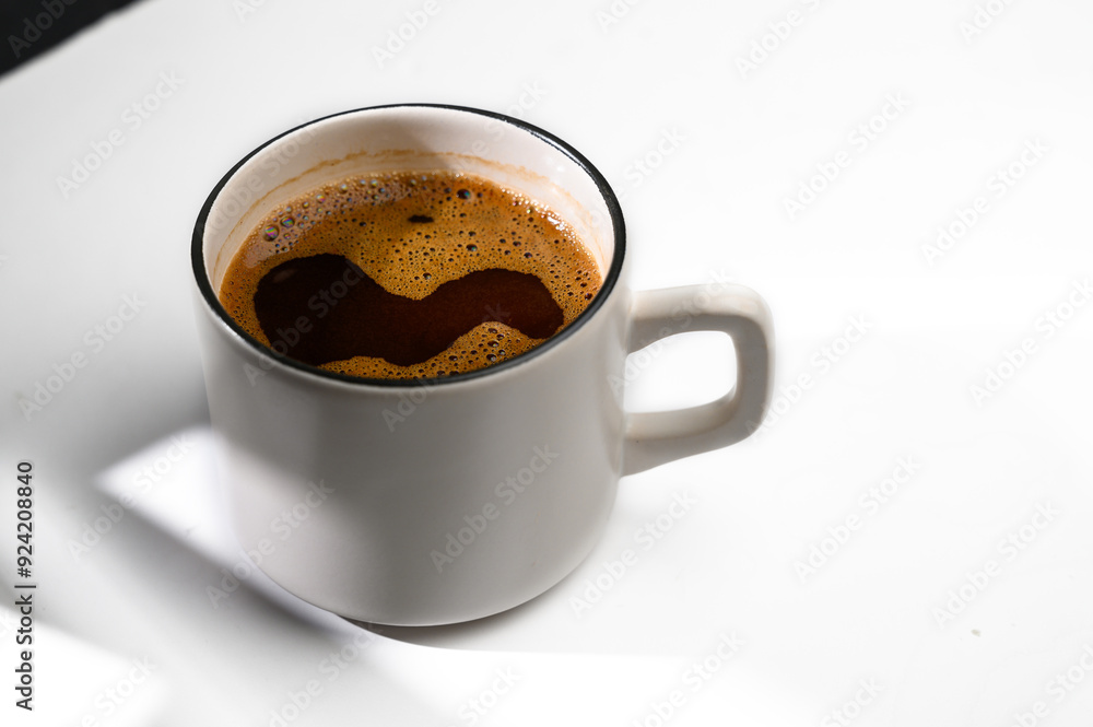 White cup of coffee in soft light isolated on a white background. Top view White cup of coffee in soft light isolated on a white background. Top view