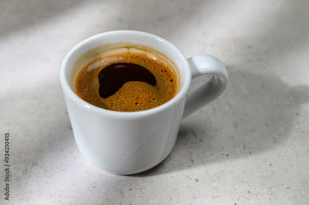 Beautiful coffee cup on the table top in a modern home kitchen. Beautiful coffee cup on the table top in a modern home kitchen.