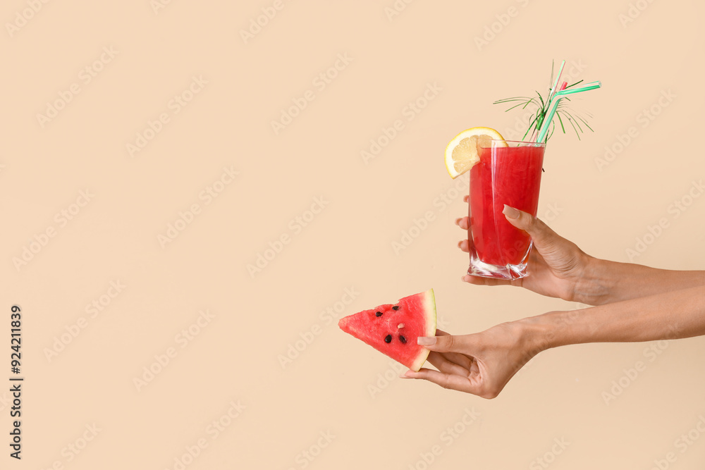 Female hands with piece of sweet watermelon and glass of fresh juice on beige background Female hands with piece of sweet watermelon and glass of fresh juice on beige background