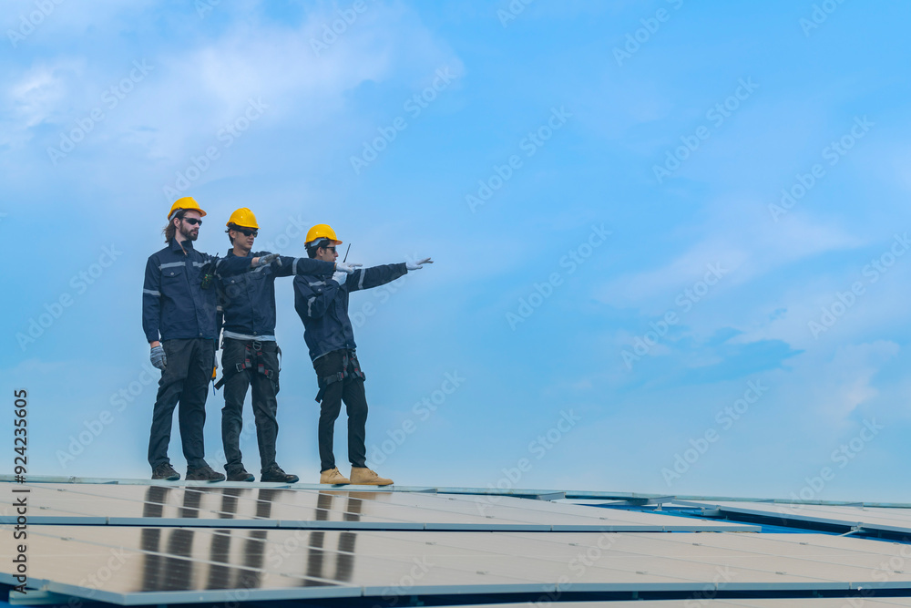 Worker Technicians are working to construct solar panels system on roof. Installing solar photovoltaic panel system. Men technicians walking on roof structure to check photovoltaic solar modules. Worker Technicians are working to construct solar panels system on roof. Installing solar photovoltaic panel system. Men technicians walking on roof structure to check photovoltaic solar modules.