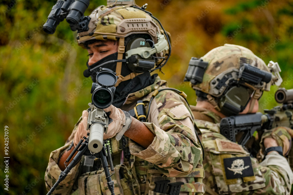 A group of military men in combat gear patrol in the middle of a desert and tropical jungle. Soldiers in full combat gear in dry weather conditions assemble and march on a mission. A group of military men in combat gear patrol in the middle of a desert and tropical jungle. Soldiers in full combat gear in dry weather conditions assemble and march on a mission.