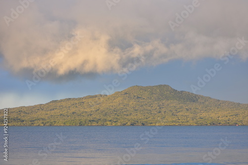 Storm clouds developing above Rangitoto volcano cone. Location: Takapuna Auckland New Zealand