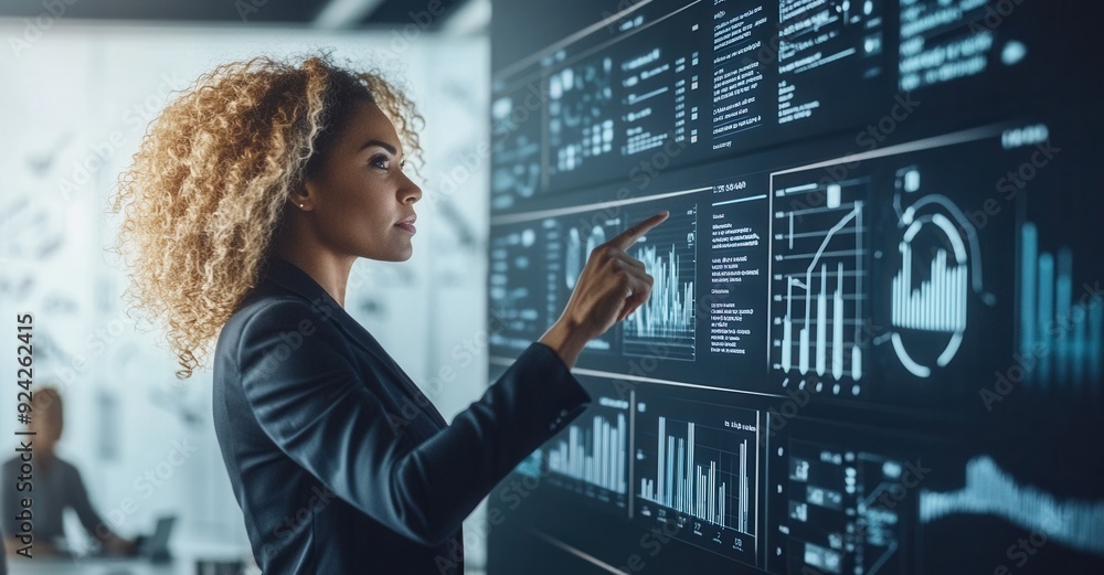 A female business professional presenting a digital report in front of a screen with graphs, charts and data visualization lines in a professional office setting, technology and stability concept A female business professional presenting a digital report in front of a screen with graphs, charts and data visualization lines in a professional office setting, technology and stability concept