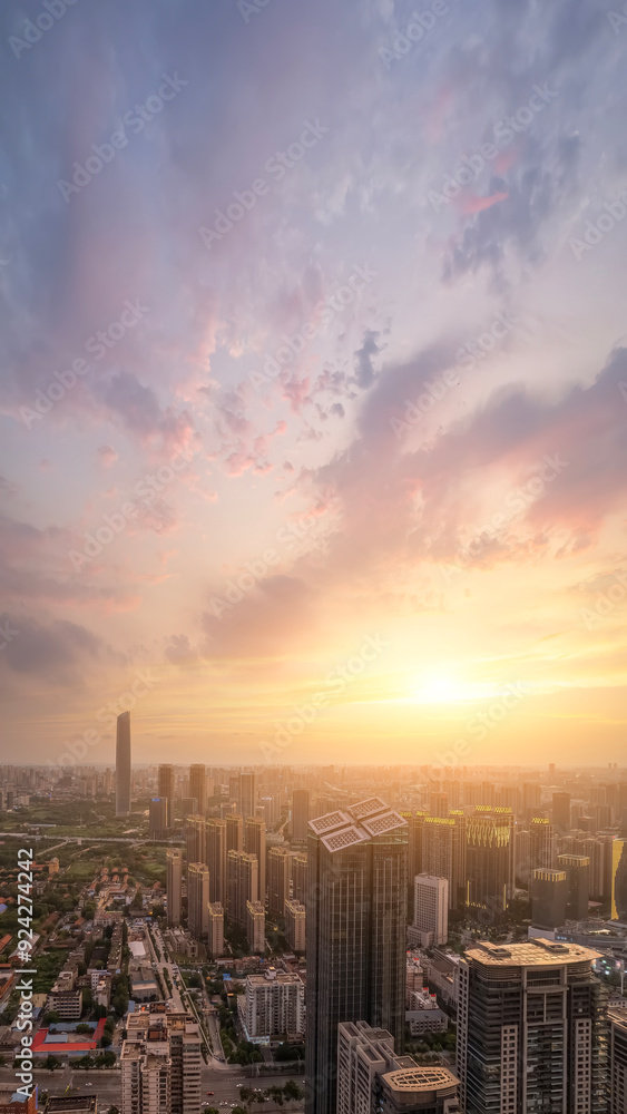 Fototapeta premium Stunning Urban Sunset Over City Skyline with Clouds and Skyscrapers