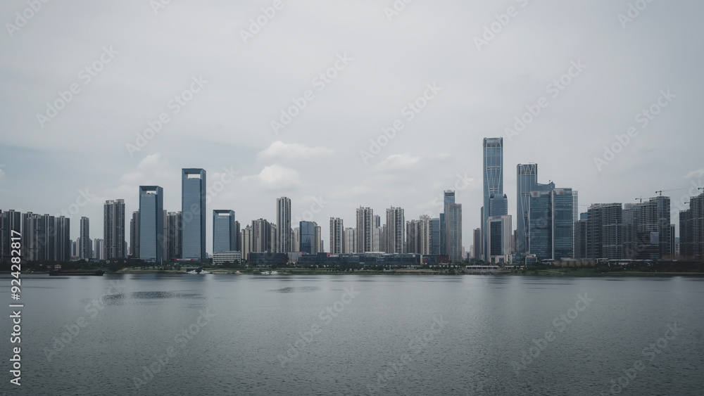 Captivating Urban Skyline Reflected in Calm Water Under a Cloudy Sky Captivating Urban Skyline Reflected in Calm Water Under a Cloudy Sky