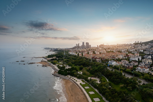 Aerial View of Serene Coastal Sunset Over Urban Landscape