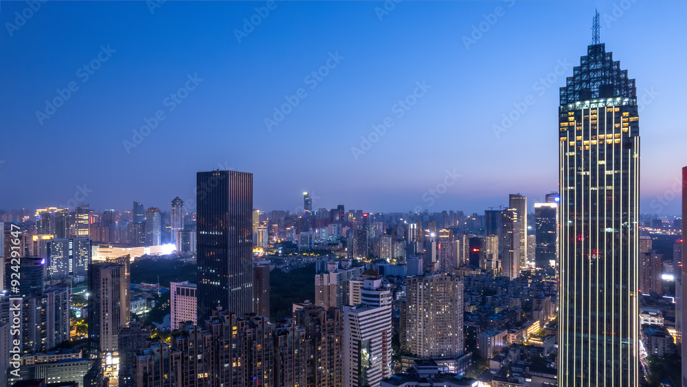 Fototapeta premium Stunning Nighttime Cityscape with Illuminated Skyscrapers