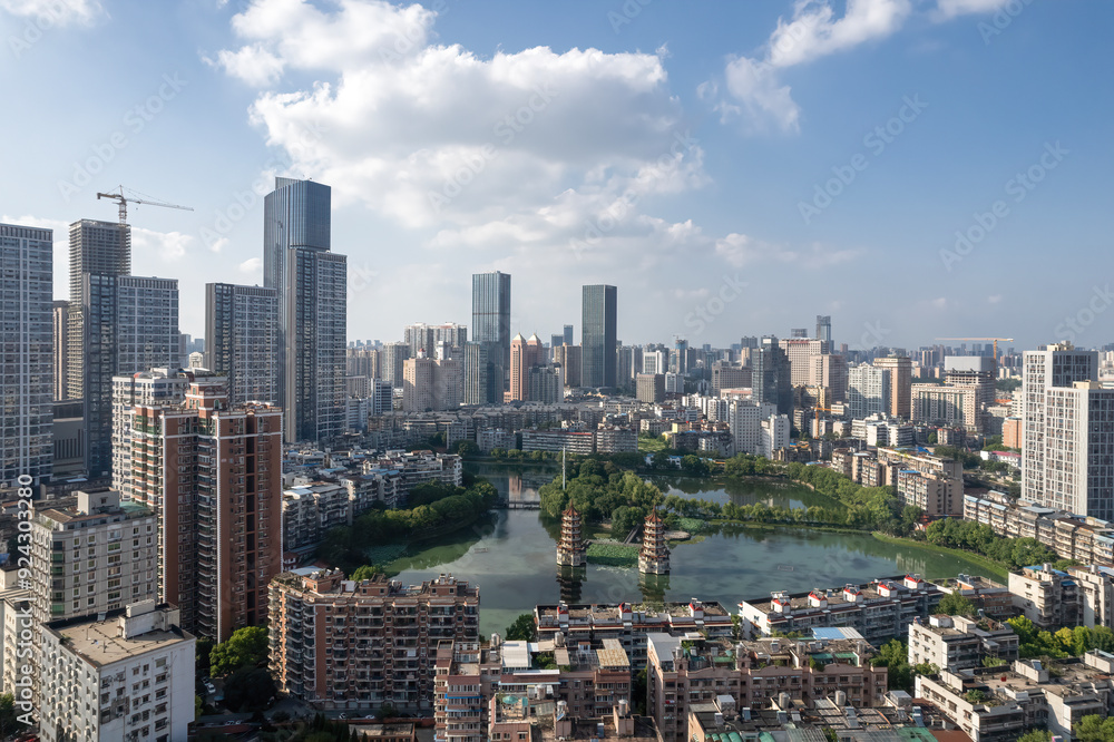 Naklejka premium Modern Urban Landscape with Scenic Lake and Skyscrapers