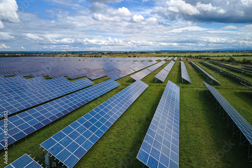 Obraz na płótnie Aerial view of big sustainable electric power plant with many rows of solar photovoltaic panels for producing clean electrical energy