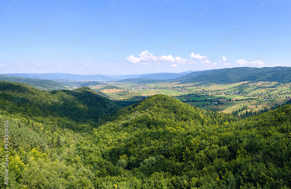 Aerial view of mountain hills covered with dense green lush woods on bright summer day Aerial view of mountain hills covered with dense green lush woods on bright summer day