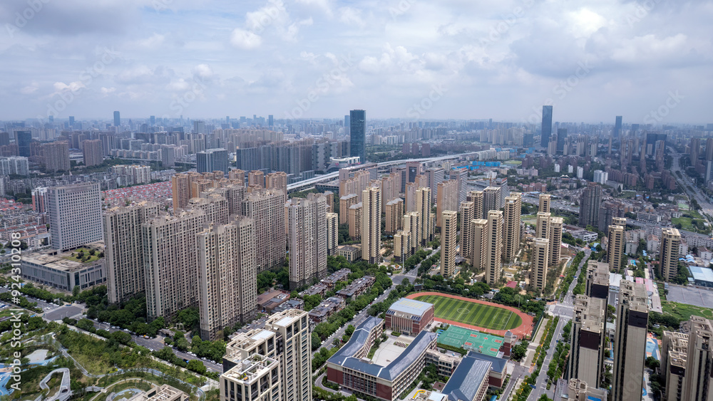 Fototapeta premium Aerial View of Urban Landscape Featuring Modern Architecture and Green Spaces