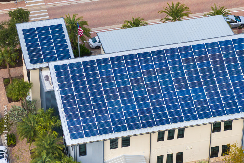 Fototapeta premium Autonomous building in Florida with photovoltaic rooftop covered with solar panels for producing of clean ecological electrical energy in town center