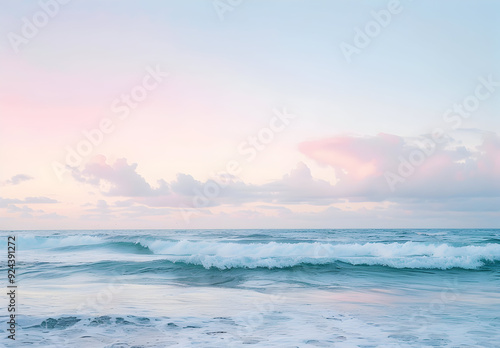 A serene seascape with gentle waves crashing on the shore under a pastel sky.