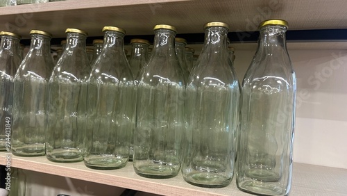 Transparent glass bottles in a row.Production of glass bottles for beverages.display of bottles in a shop photo