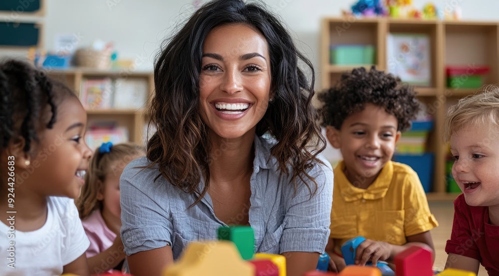 Smiling Hispanic Teacher Engaging with Multicultural Preschool Children in Classroom Smiling Hispanic Teacher Engaging with Multicultural Preschool Children in Classroom