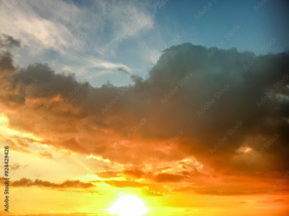 Fototapeta premium Blue yellow and gold gradient sky with clouds 