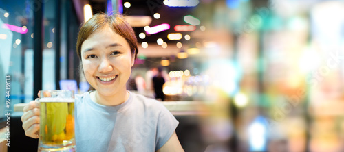 Asian beautiful woman enjoy eating a Korean Bar-B-Q and drinking a beer.