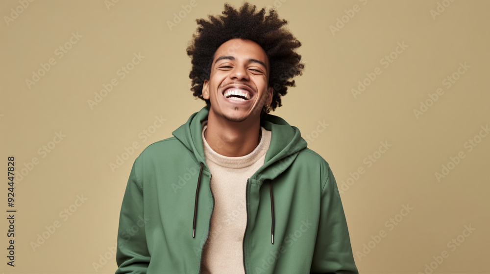 A portrait of an attractive mixed-race man in his late 20s, laughing heartily. A portrait of an attractive mixed-race man in his late 20s, laughing heartily.