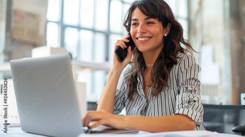 A beautiful professional woman uses a laptop in a modern office A beautiful professional woman uses a laptop in a modern office