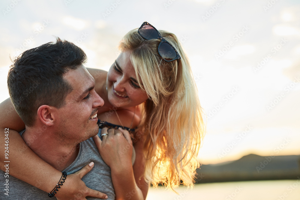 Couple, piggyback and sunset in nature for vacation, relax and travel with love and leisure in California. People, bonding and happy outdoor for holiday, relationship and adventure with smile by lake Couple, piggyback and sunset in nature for vacation, relax and travel with love and leisure in California. People, bonding and happy outdoor for holiday, relationship and adventure with smile by lake