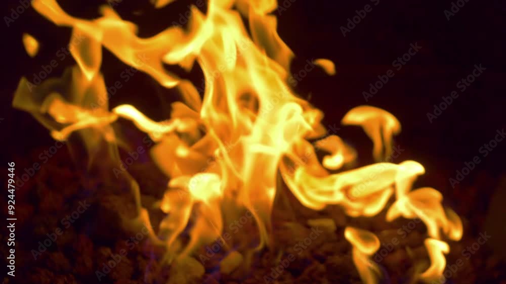 Close up of flickering flames in a fire pit, evoking warmth and relaxation in 4k slow motion 60fps Close up of flickering flames in a fire pit, evoking warmth and relaxation in 4k slow motion 60fps